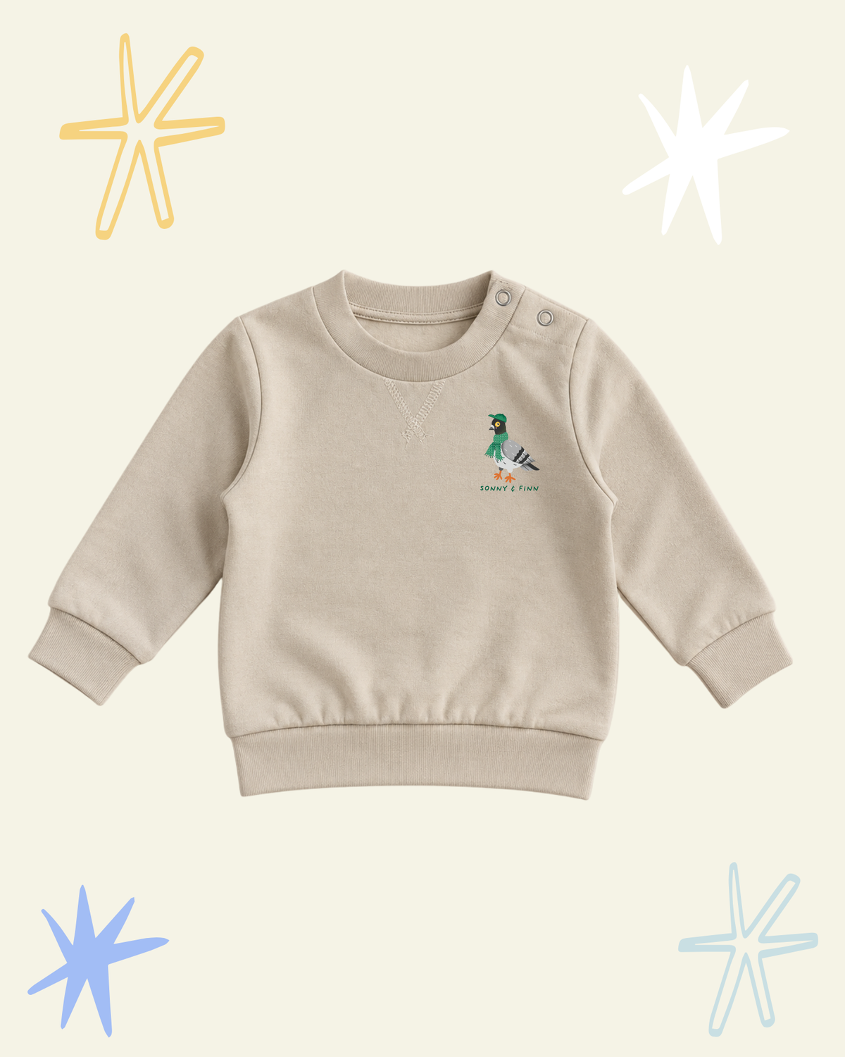 Front of beige Stay Coo. sweatshirt with shoulder poppers and a small pigeon above the Sonny and Finn logo.