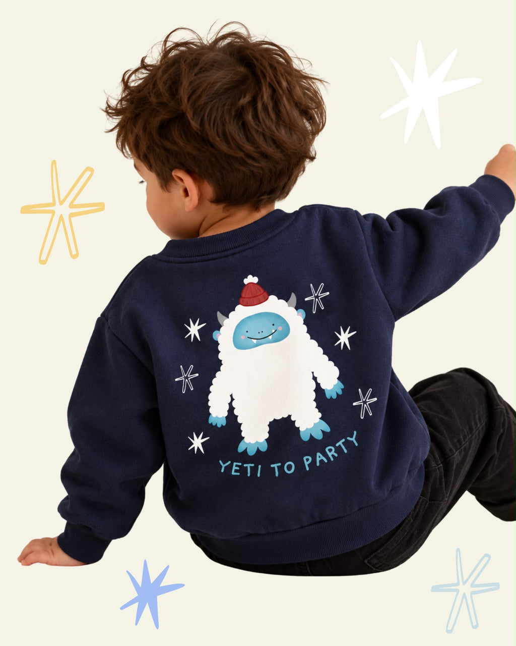 Child wearing a navy Yeti to Party sweatshirt with a smiling white yeti in a red hat printed on the back.