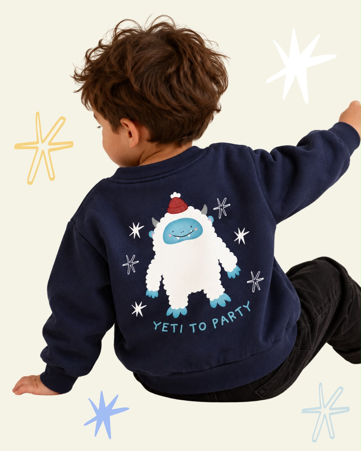 Child wearing a navy Yeti to Party sweatshirt with a smiling white yeti in a red hat printed on the back.