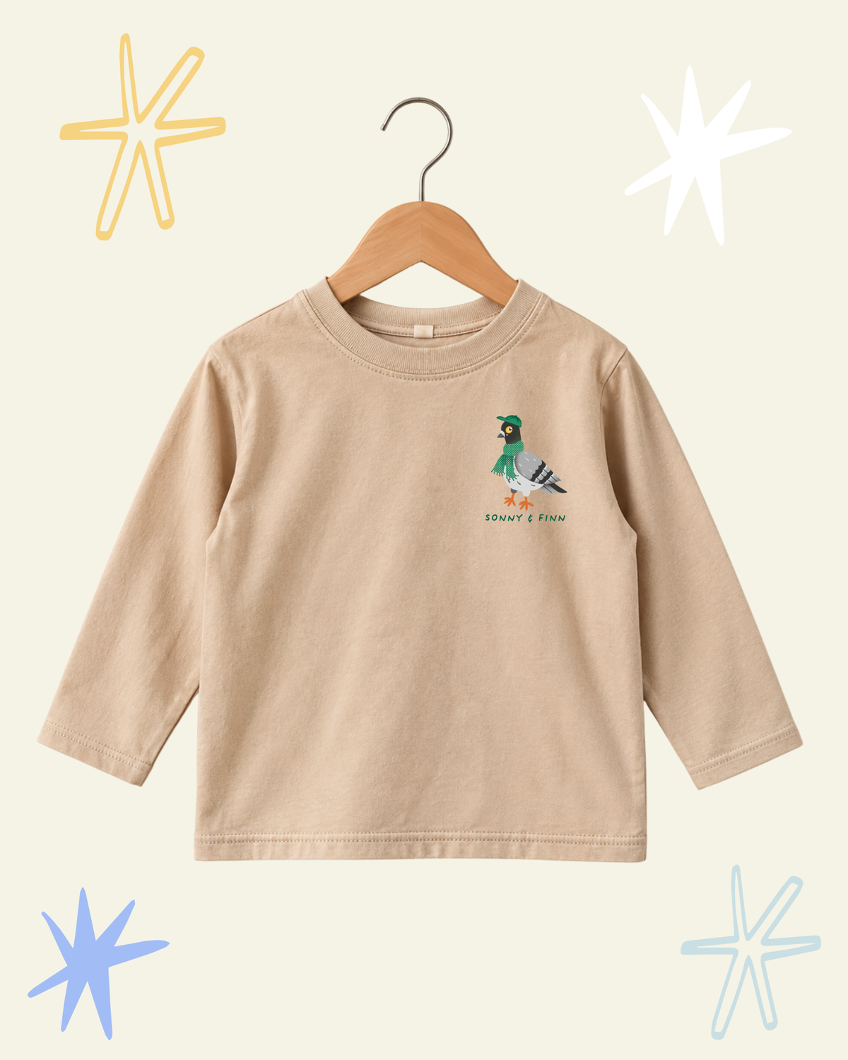 Front of beige Stay Coo. long sleeve T-shirt with a small pigeon illustration above the Sonny and Finn logo.
